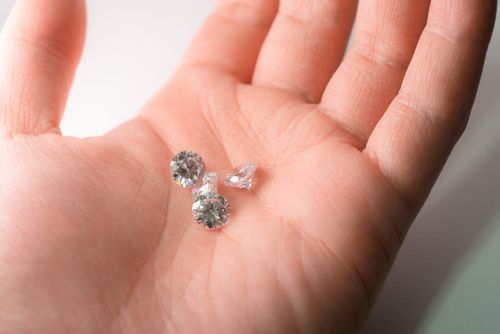 Free Glistening diamonds resting in the palm, showcasing luxury and elegance. Stock Photo
