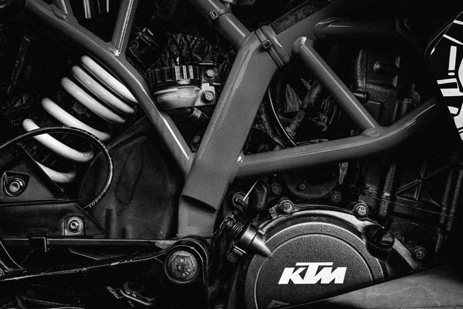 Detailed black and white view of KTM motorcycle engine components showcasing mechanical design.