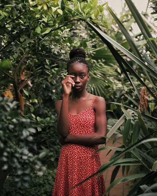 Woman Wearing a Summer Dress Posing in a Botanic Garden 