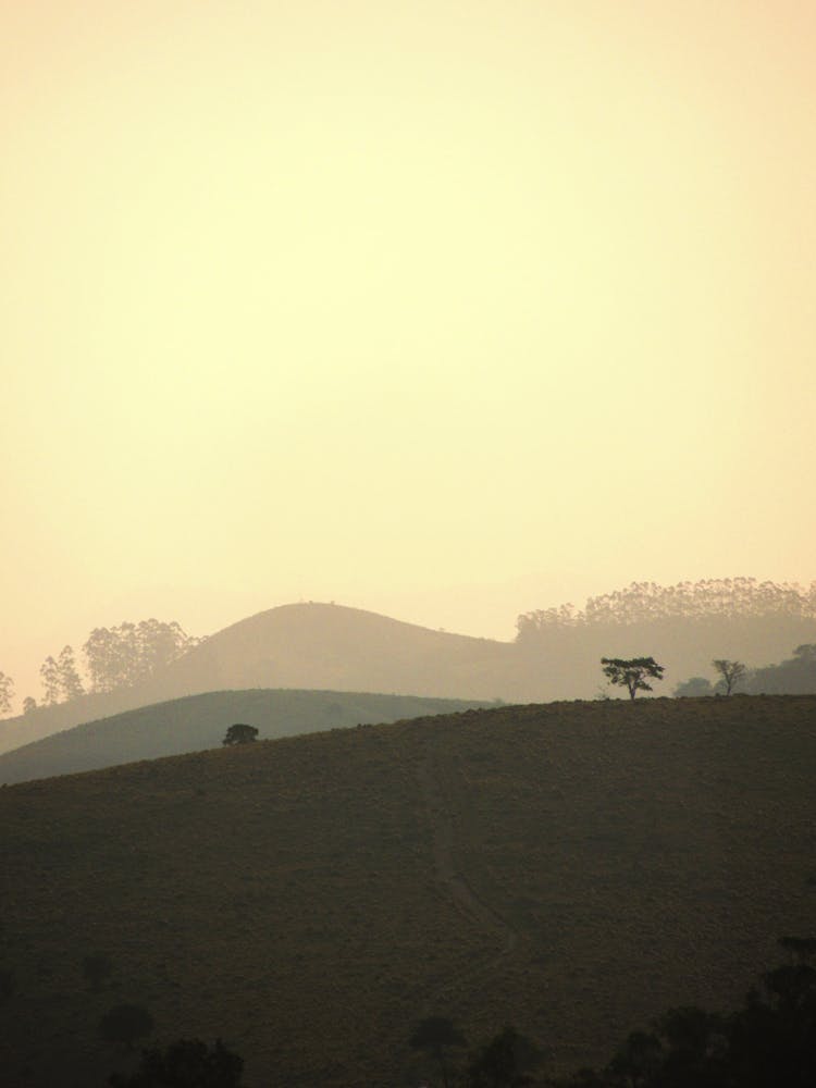 Silhouettes Of Hills At Sunrise