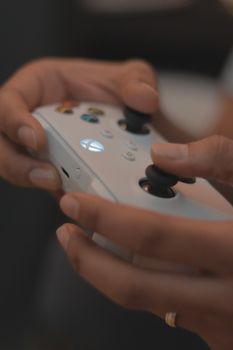 Close-up of hands gripping a game controller in Dubai, emphasizing gaming in the urban lifestyle.