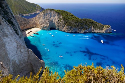 Free A stunning overhead view of Navagio Beach, showcasing its turquoise waters, sandy shore, and surrounding cliffs in Greece. Stock Photo