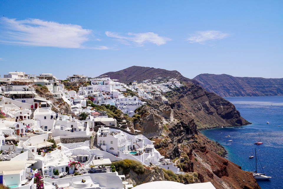 Whitewashed village above an Aegean cove on a Greek island