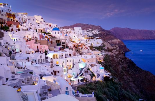 Captivating sunset view of iconic Santorini architecture against the Aegean Sea.