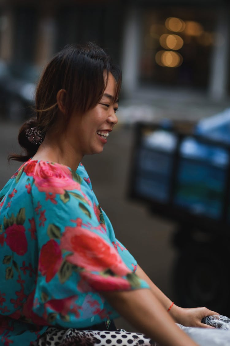 Young Woman In A Floral Dress Smiling 