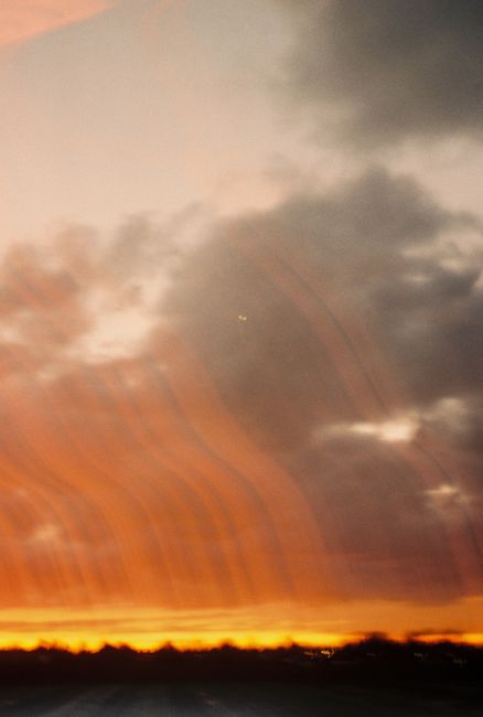 Captivating orange sunset with clouds and horizon silhouette, perfect for peaceful evening themes.