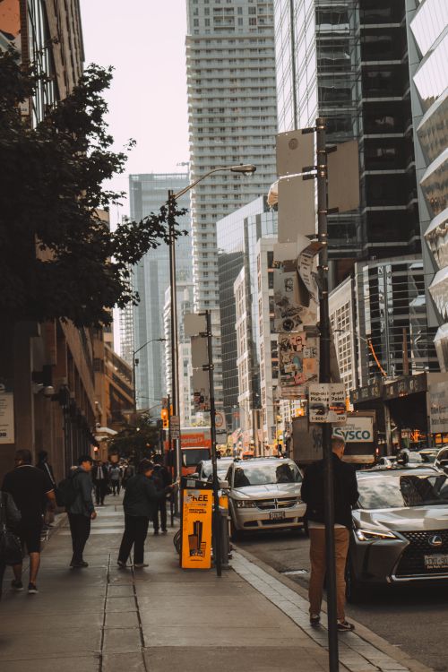 Free A busy city street with people walking and skyscrapers in the background, capturing urban life. Stock Photo