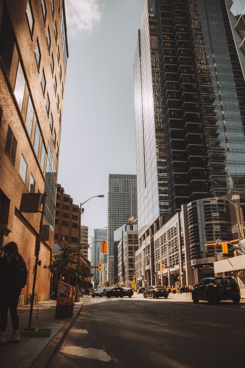 Free Dramatic cityscape with towering skyscrapers and bustling street life. Stock Photo