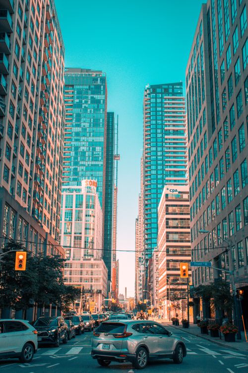 Free Dynamic urban scene of a busy city street surrounded by modern skyscrapers capturing traffic and architecture. Stock Photo
