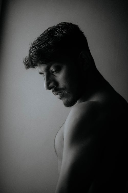 Free Monochrome portrait capturing the contemplative expression of a shirtless Asian man. Stock Photo