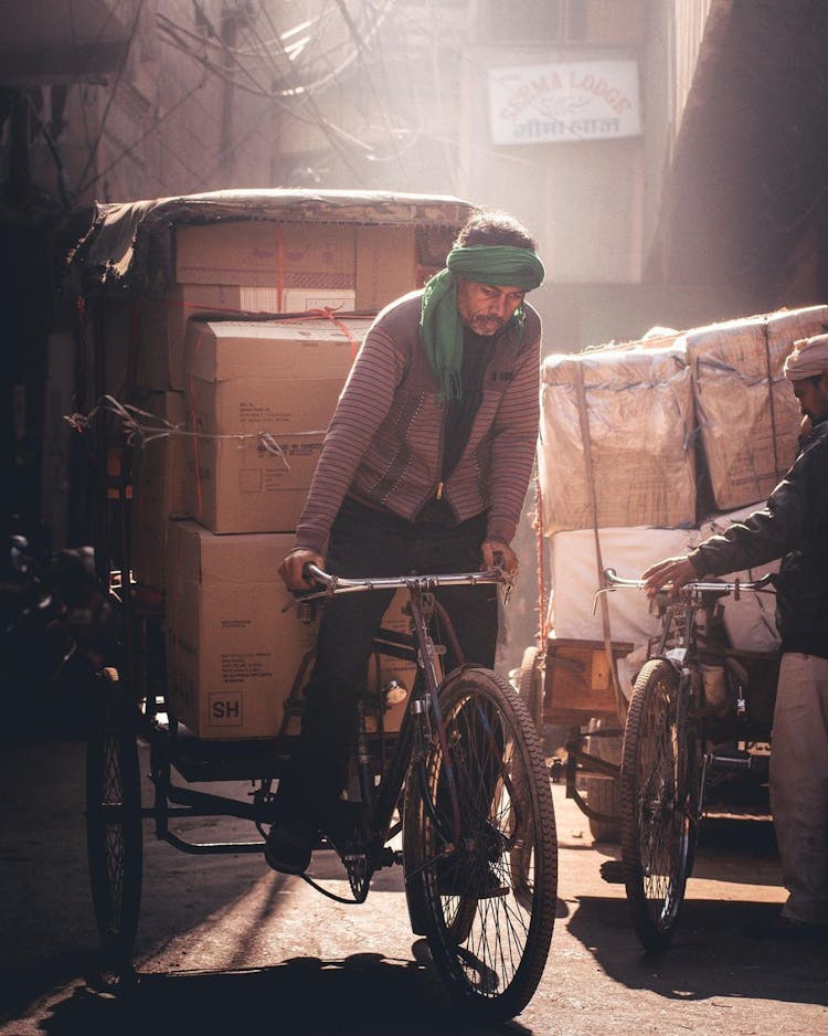 Man Transporting Boxes On Rickshaw