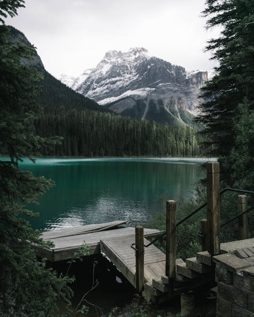 Body of Water Near Snow-capped Mountain