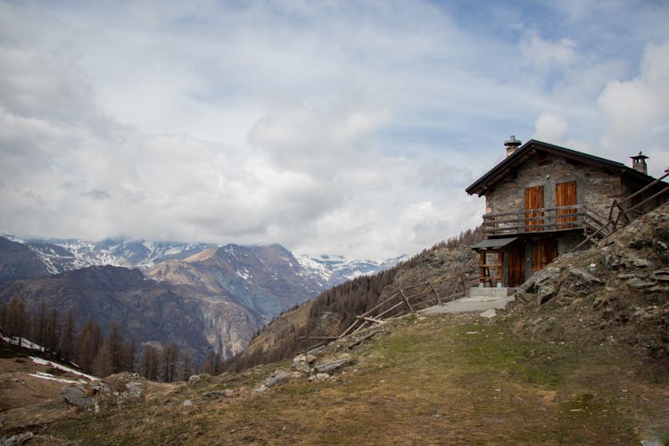 Clouds Over House In Mountains