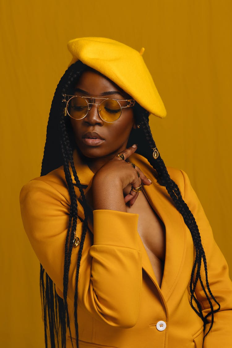 Woman Wearing All Yellow Posing In A Studio 