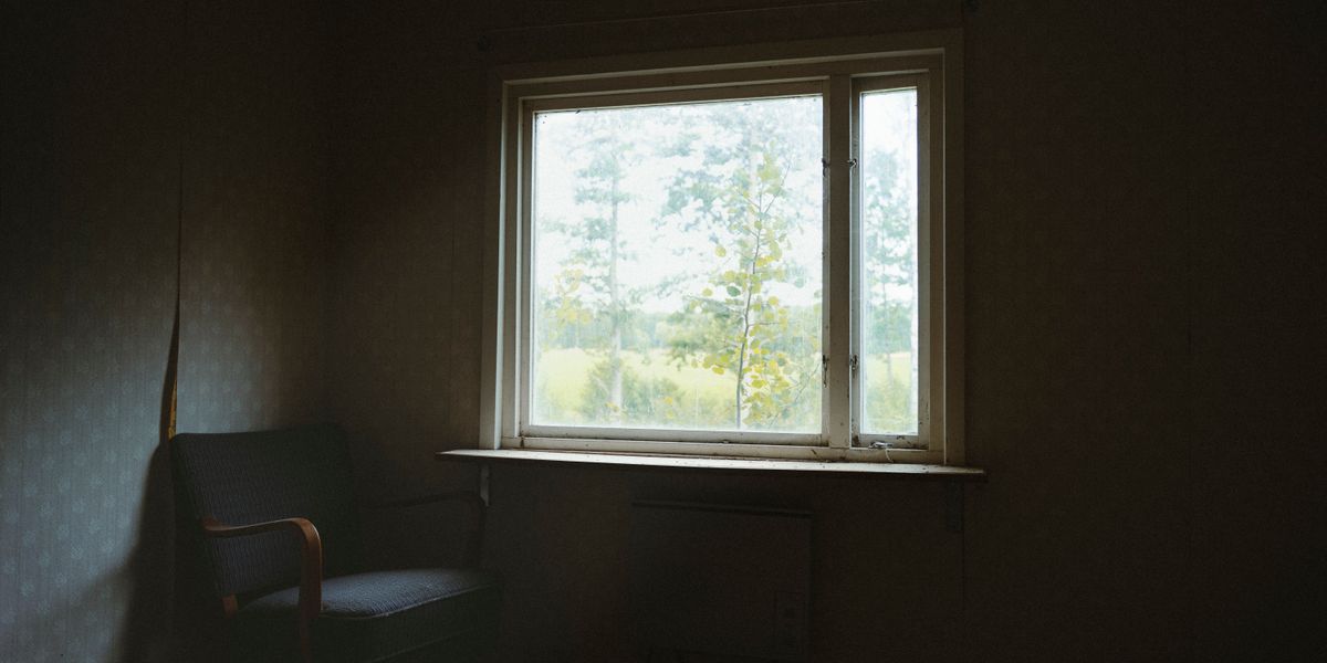 A calm chair beside a window, with soft daylight coming in