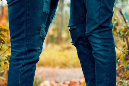 Two People Wearing Rugged Jeans 