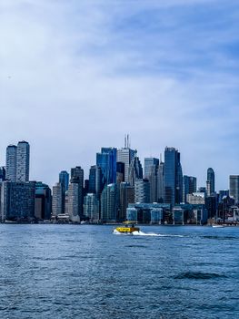 Vibrant view of Toronto's skyline featuring a water taxi in front and towering skyscrapers in the background.