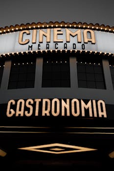 Close-up of a retro-style illuminated cinema mercado sign displaying 'Gastronomia'.
