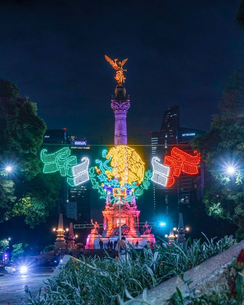 Free Night view of the Angel of Independence monument in Mexico City, beautifully lit with colorful lights. Stock Photo