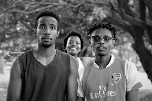 Three young adults in Nairobi park enjoying a sunny day outdoors.