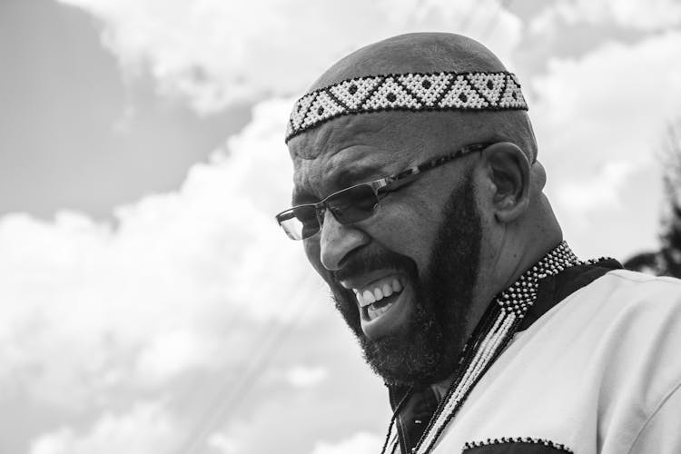 Grayscale Photo Of A Man With Sunglasses Laughing