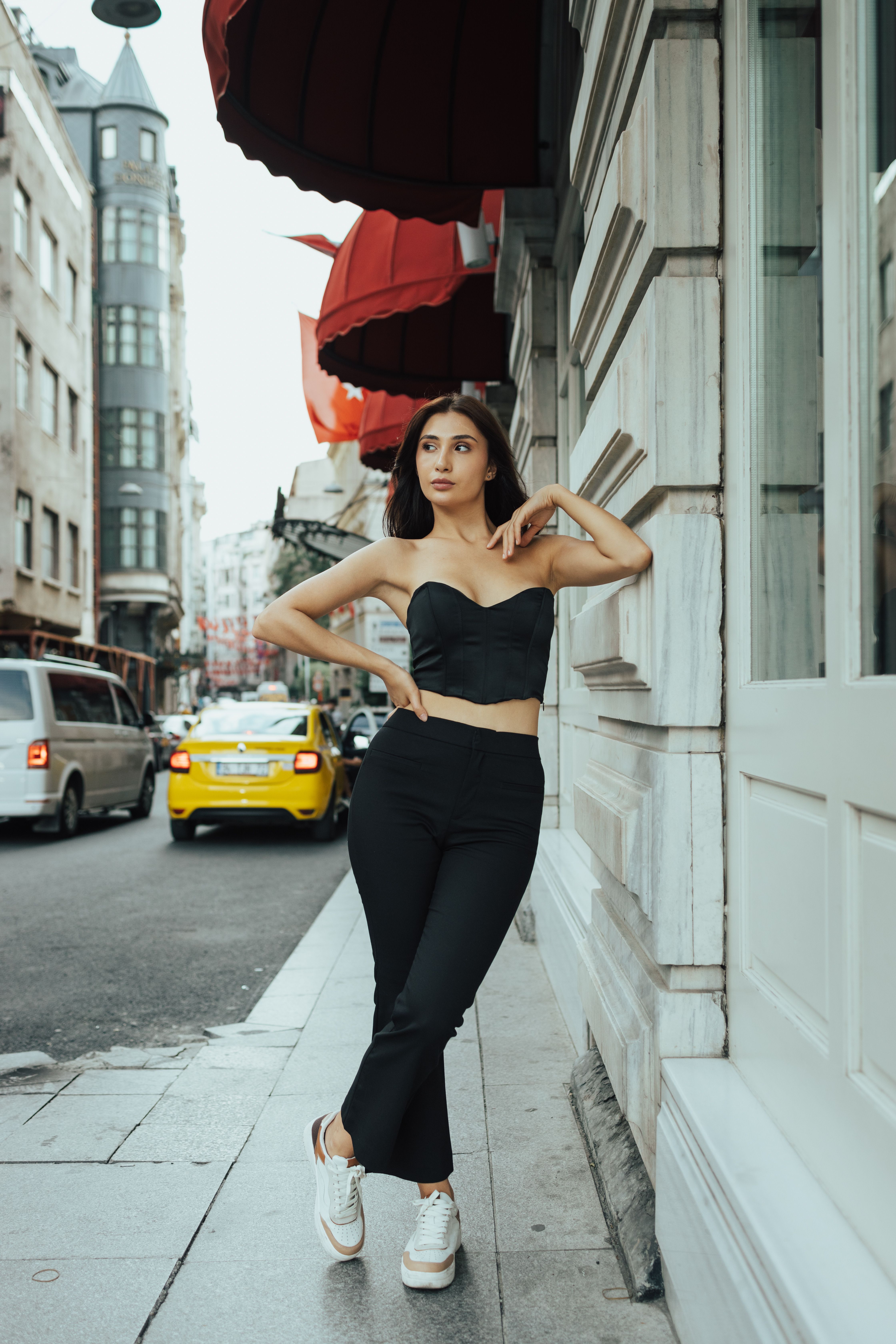 Woman in paperbag waist trousers and crop top