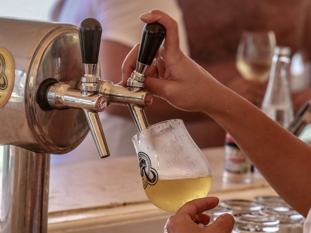 A Person Getting Beer from a Beer Tap · Free Stock Photo