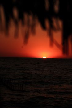 A captivating sunset over the ocean, creating a dramatic and picturesque scene.