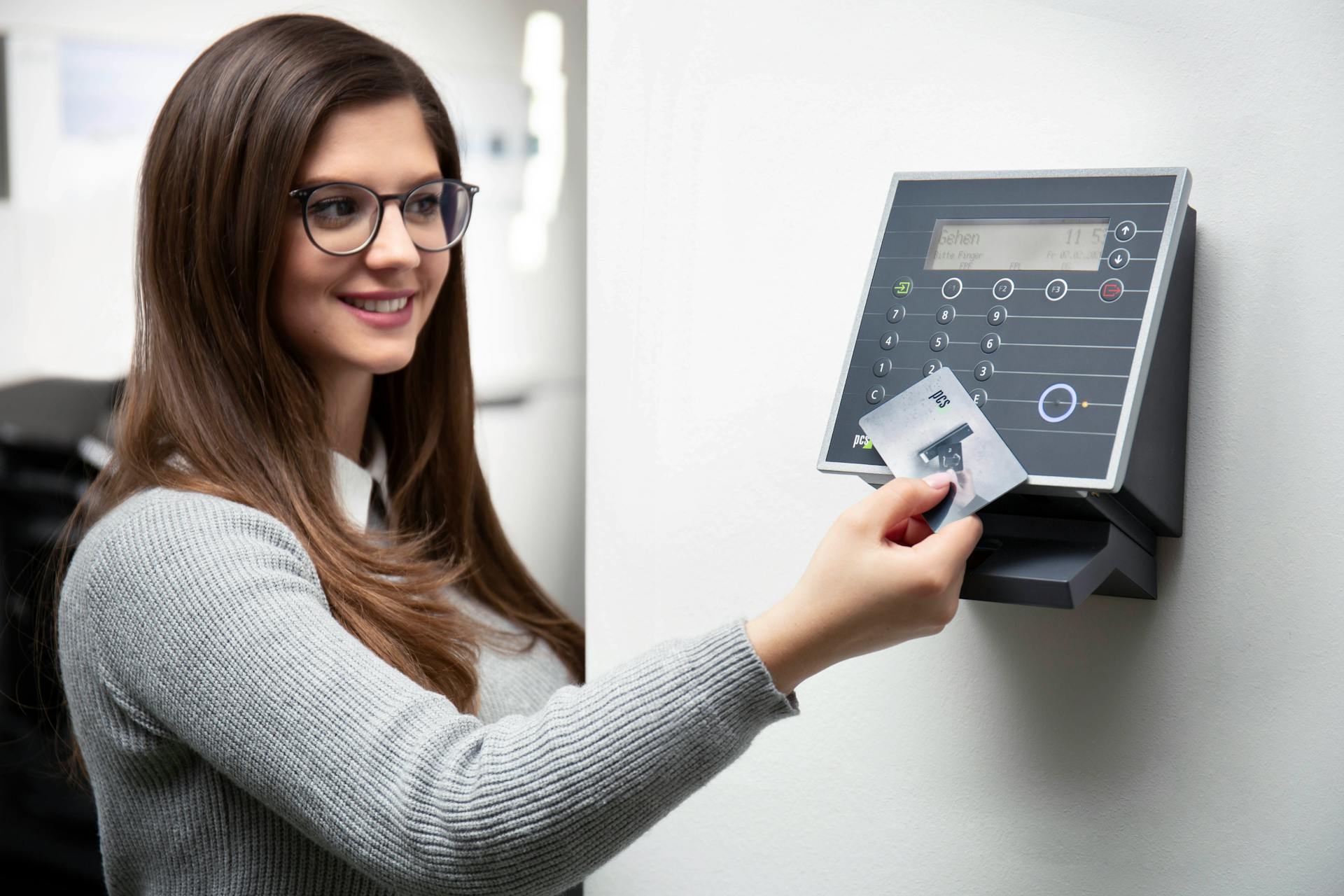 Smiling Woman Holding Access Card over Reader