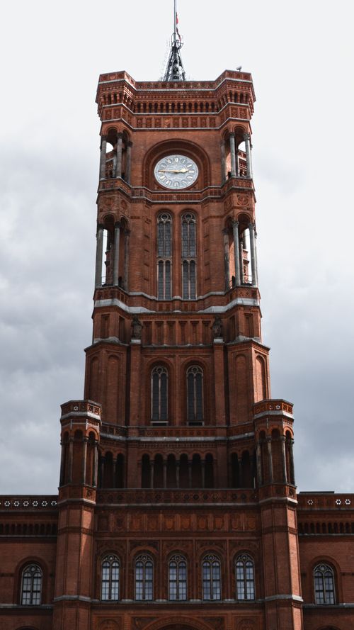 Free Vertical shot of the iconic Rotes Rathaus tower in Berlin, famous for its red brick architecture. Stock Photo