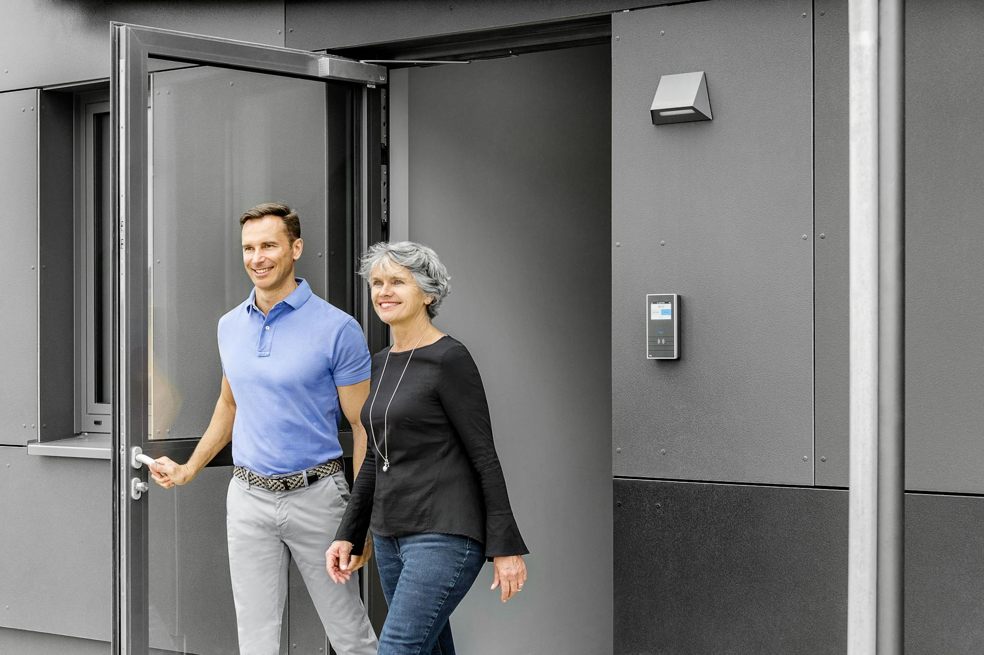 Smiling Man and Woman Leaving Building