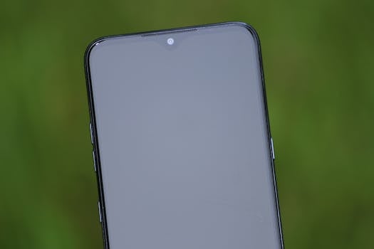 Close-up view of a smartphone screen with a green background, ideal for tech themes.