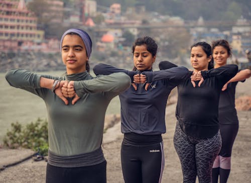 A Group of Women Exercising Outdoors 