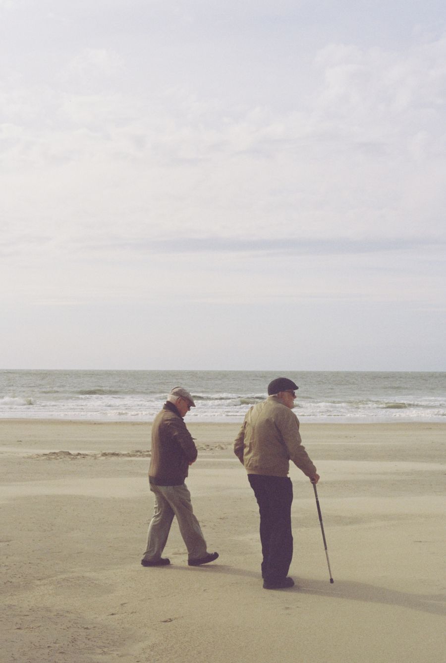 Two senior men enjoying a peaceful beach walk