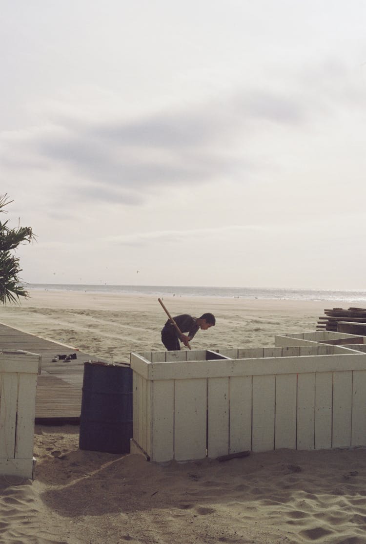 Man Cleaning On The Beach