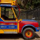 Vibrant traditional chiva bus parked outdoors in Barbosa, Colombia.