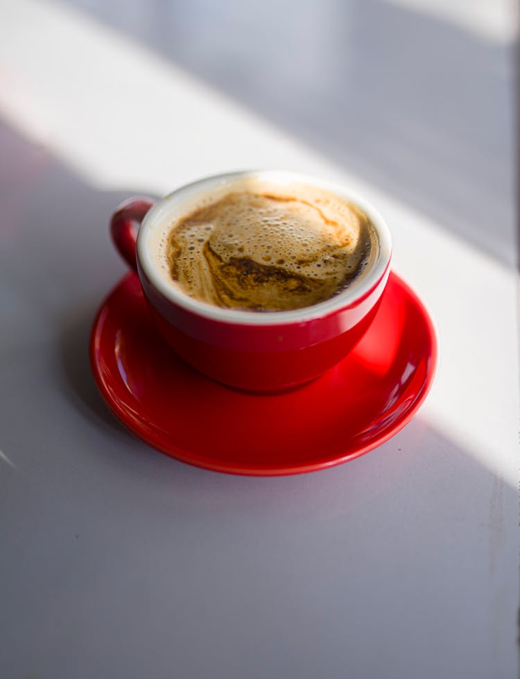 A Coffee On Red Cup With Saucer