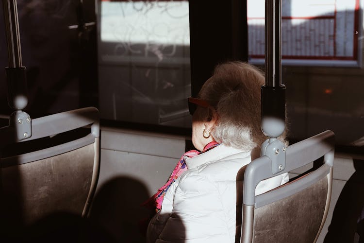 Elderly Woman Riding A Bus