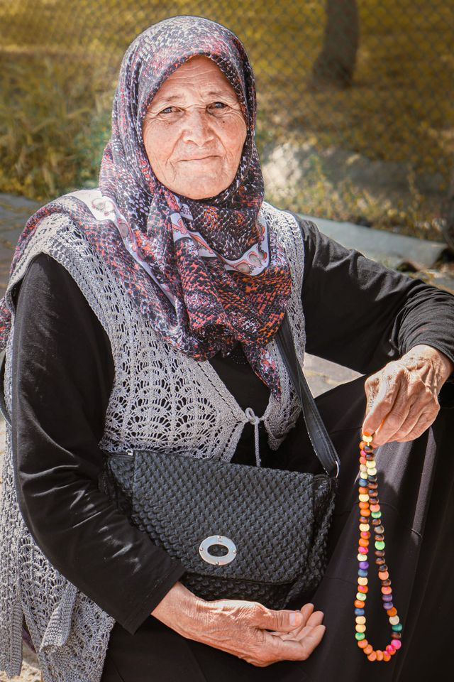 Portrait of an older woman in a headscarf — photo by Rueveyda on Pexels