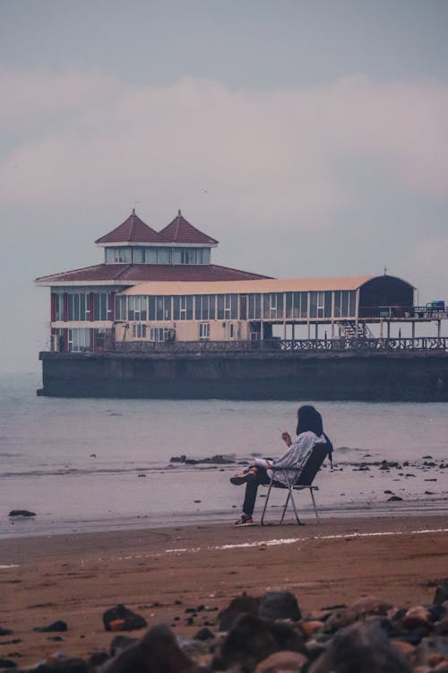 A Person Sitting on the Chair while Looking at the Beautiful Scenery