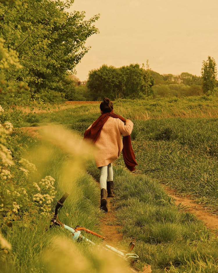 Girl Running On Green Grass Field