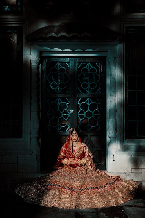 Beautiful Woman Wearing a Bridal Gown Sitting by the Doorway
