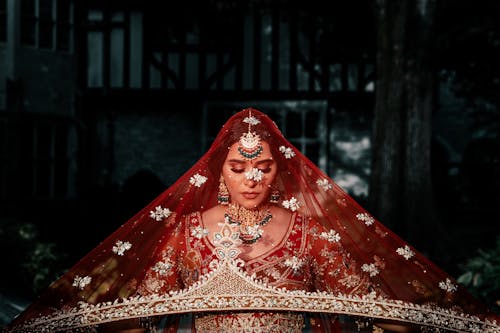 Photo of a Bride with a Red Veil