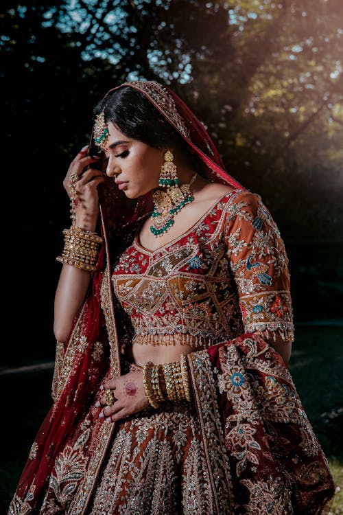 Woman in Red Traditional Clothing Holding Veil