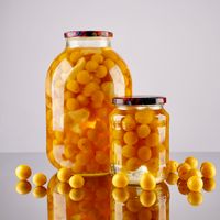Preserving jars of fruit on a pale shelf, photo by Marta Dzedyshko on Pexels