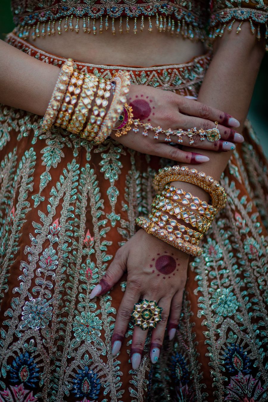 Gold-look stack bangles being worn, finished by Sunlight's in Surat