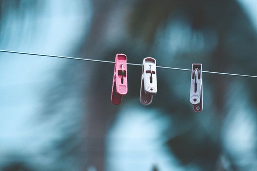 Three Clothespins on Clothesline