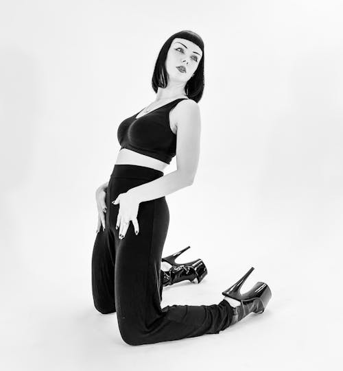 Grayscale Photo of a Woman in a Crop Top and Pants