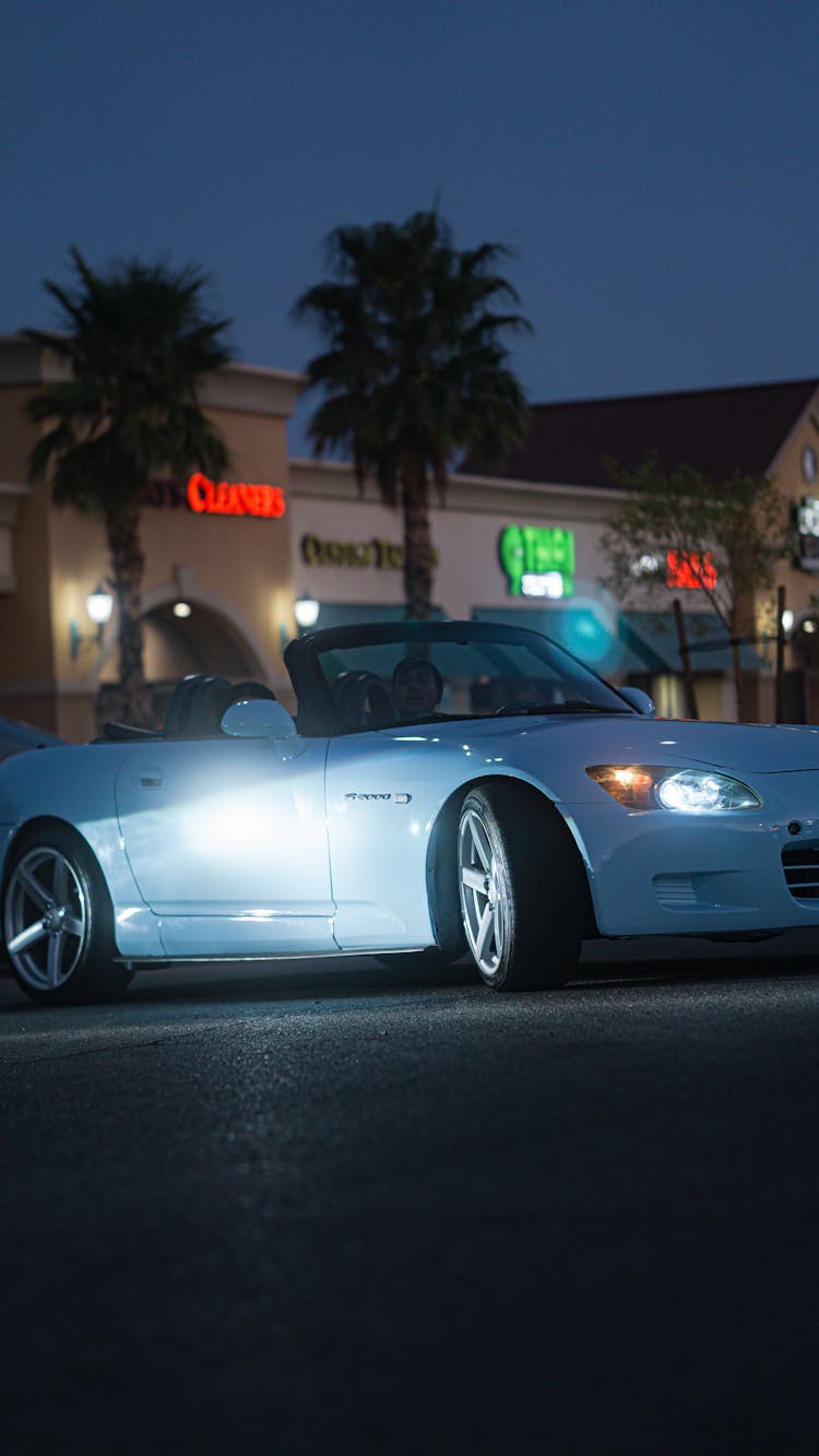 A White Car On The Road At Night