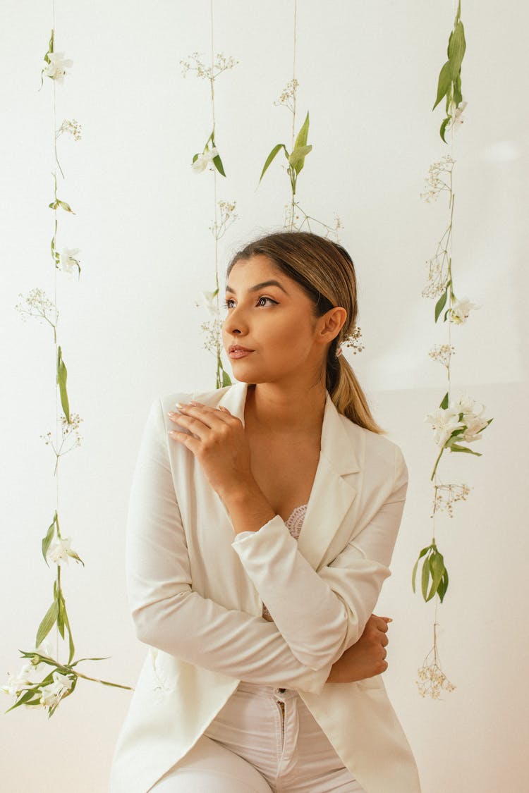 Young Woman Posing On Flowers Decorations Background